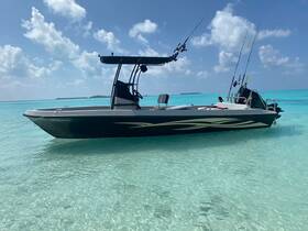 A sleek speedboat anchored in crystal-clear turquoise waters, showcasing its design against a stunning tropical backdrop.