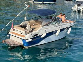 A couple enjoys a relaxing day on a boat, soaking up the sun and the beautiful waters — perfect for a summer getaway.
