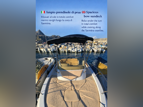 A spacious bow sundeck on a boat, perfect for relaxing under the sun while cruising along the beautiful Taormina coastline.