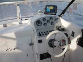 A detailed view of the helm and console area inside a boat, showcasing the navigation equipment and controls, ideal for understanding boat operations.