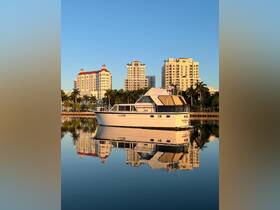 A stunning yacht docked peacefully, reflecting the surrounding skyline in calm waters — a perfect representation of luxury boating.