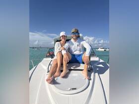 A couple enjoys a sunny day on the bow of a boat, perfect for romantic outings or fun adventures on the water.