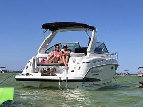 Two friends relax on the deck of a boat, enjoying a sunny day on the water — a perfect setting for summer fun and relaxation.
