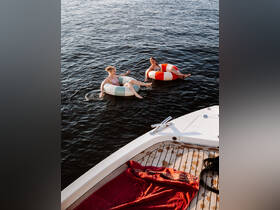 Two friends enjoy a fun day on the water, floating in colorful tubes — a perfect summer activity for relaxation and enjoyment.