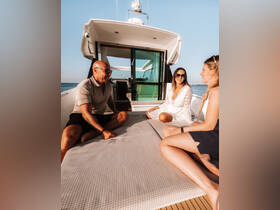 A group of friends enjoys a relaxing moment on the deck of a boat, perfect for socializing and soaking up the sun on the water.