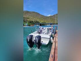 A sleek speedboat is docked in tranquil waters, showcasing its powerful twin engines and inviting seating area, perfect for a day on the water.
