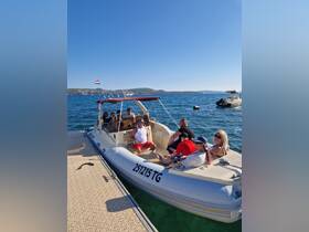 A lively group enjoys their time aboard a boat docked at a picturesque location, perfect for creating unforgettable memories on the water.