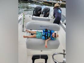 A child relaxes on a boat wearing a life jacket and sunglasses, capturing a fun and safe day on the water.