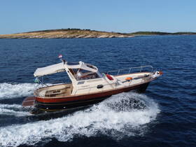 A sleek speedboat glides through the clear blue waters, showcasing its elegant design and perfect for thrilling adventures on the open sea.