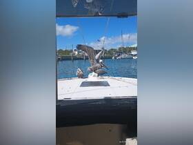 A pair of pelicans perched on the bow of a boat, showcasing a serene moment in nature — perfect for birdwatching enthusiasts.