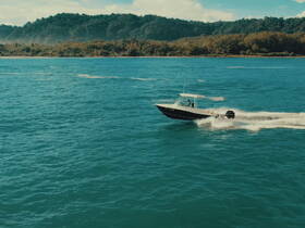 A sleek speedboat navigates through vibrant turquoise waters, showcasing the thrill of boating adventures in a picturesque setting.