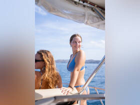 Two friends enjoy a sunny day on a boat, capturing the essence of fun and relaxation on the water.