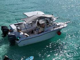 A well-equipped boat is anchored in clear turquoise waters, showcasing its sleek design and inviting atmosphere for a day on the water.