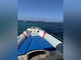 A view from the front of a speedboat showcasing its comfortable seating and a distant lighthouse, perfect for a day out on the water.