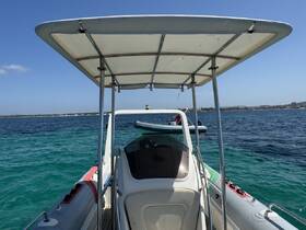 A clear view of a center console boat cruising through turquoise waters, showcasing its sleek design and perfect for day trips on the water.