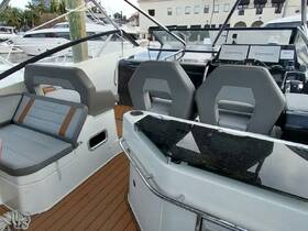 A sleek interior view of a boat's helm and seating area, showcasing modern design and comfortable amenities for an enjoyable boating experience.