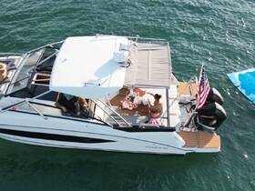 A group enjoys a relaxing day on a boat, sharing food and drinks while soaking up the sun — perfect for a fun day on the water.