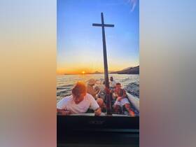 A group enjoys a sunset boat ride, capturing the essence of adventure and camaraderie on the water.