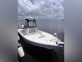 A sleek center console boat docked in calm waters, showcasing its spacious design and modern features, perfect for fishing or leisure outings.