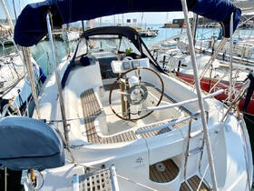 A well-equipped helm area of a sailboat, showcasing the steering wheel and seating, perfect for navigating the open waters.