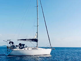 A sleek sailboat named 'Controluce' glides through calm waters under a clear blue sky, perfect for sailing enthusiasts and ocean adventures.