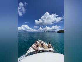 A group of friends relaxes on the bow of a boat, soaking up the sun and enjoying the beautiful ocean views — perfect for a day of leisure on the water.