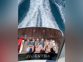A group of friends relaxes on the deck of a yacht, enjoying drinks and the sun while cruising through beautiful waters — the perfect setting for a summer getaway.