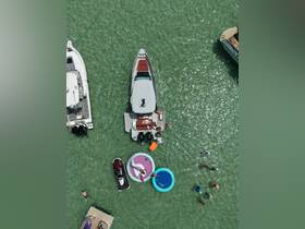A lively scene of friends enjoying a day on the water, with floating mats and a jet ski, perfect for summer fun and water activities.