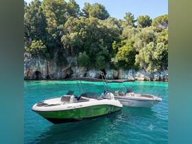 Two speedboats anchored in crystal-clear waters, surrounded by lush greenery — perfect for exploring the beautiful coastline of Corfu.