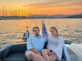A couple enjoys a romantic sunset on a boat, creating the perfect backdrop for memorable moments on the water.
