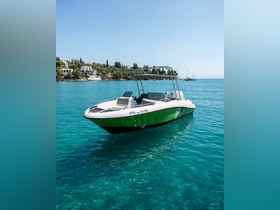 A sleek speedboat anchored in crystal-clear waters, showcasing its vibrant design against a picturesque coastal backdrop.