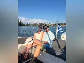 A couple enjoys a sunny day on a boat, capturing the essence of relaxation and adventure on the water.