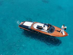 A couple enjoys a romantic moment on a stylish boat in crystal-clear waters, perfect for unforgettable celebrations and getaways.