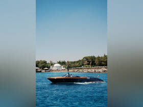 A sleek speedboat glides through the clear blue waters, showcasing a perfect day for boating adventures. Ideal for exploring coastal destinations or enjoying a day on the water.