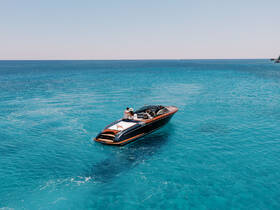 A couple enjoys a romantic moment aboard a sleek boat, gliding through the stunning turquoise waters — an ideal setting for unforgettable adventures on the sea.