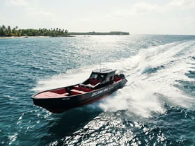 A striking aerial view of a speedboat cruising through vibrant blue waters, showcasing the vessel's sleek design and performance.