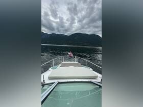 A serene view from the front of a yacht, showcasing the tranquil waters and mountainous backdrop — perfect for exploring nature on the water.
