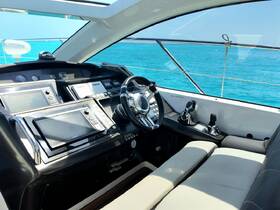 A sleek view of the helm and console area inside a luxury yacht, showcasing modern navigation equipment and comfortable seating — perfect for a day on the water.