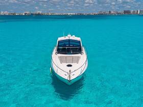 A stunning aerial view of a sleek speedboat cruising through crystal-clear turquoise waters, perfect for exploring coastal destinations.