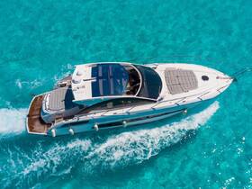 A stunning aerial view of a sleek yacht cruising through crystal-clear turquoise waters, perfect for luxury charters and island adventures.