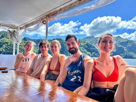A cheerful group of friends enjoys their time aboard a boat, surrounded by stunning natural scenery — perfect for memorable adventures on the water.