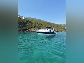A sleek boat anchored in clear turquoise waters, surrounded by lush greenery — perfect for a day of relaxation and exploration on the water.