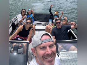 A joyful group enjoys a fun day on the boat, capturing memories with smiles and peace signs — perfect for family outings or group adventures on the water.