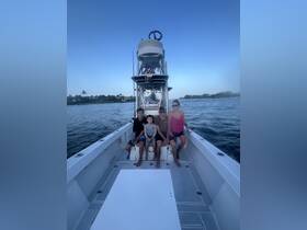 A family enjoys a fun day on the water aboard their boat, creating lasting memories together. Perfect for family outings and adventures on the sea.