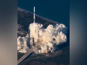 An aerial view of a rocket launch, showcasing the powerful ascent amidst clouds of smoke and fire. This image captures the excitement of space exploration.