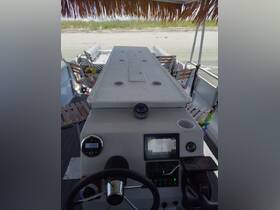An interior view of a boat's helm and console area, showcasing the steering wheel and navigation equipment, perfect for those looking to explore the waters.