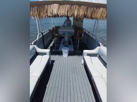 A spacious interior of a boat featuring comfortable seating and a bar area, perfect for relaxing and enjoying the water.