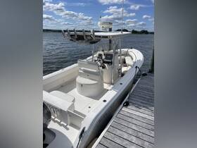 A detailed view of the helm and seating area inside a boat, showcasing the modern console and comfortable seating — perfect for fishing or leisure outings.
