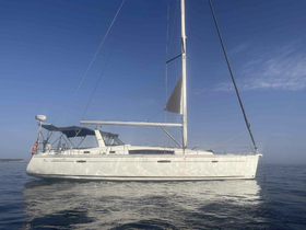 A stunning view of the Oceans 50 sailboat gliding through calm waters under a clear blue sky, perfect for sailing enthusiasts and charters.