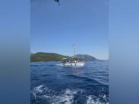 A lively boat sails through clear waters, with a group of passengers enjoying the scenic views — perfect for a day of adventure on the water.